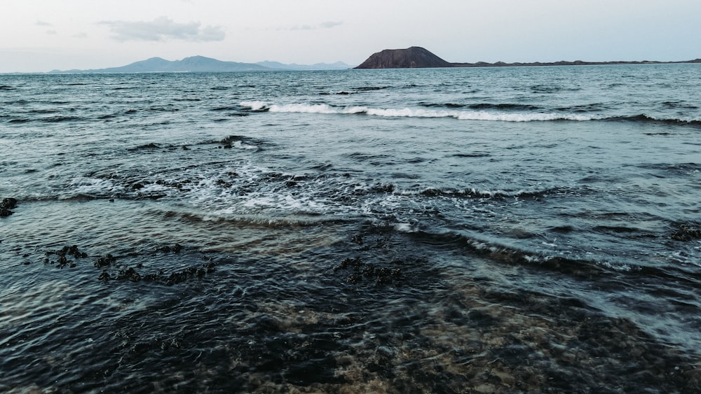 a body of water with a small island in the distance