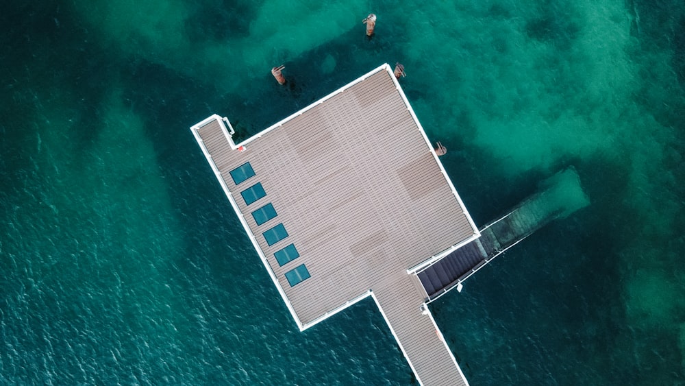 an aerial view of a dock in the ocean