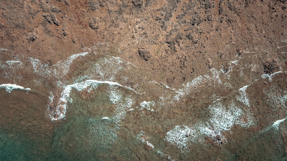 an aerial view of a sandy beach and ocean