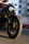 A close-up of a motorcycle parked in a vibrant urban setting.