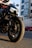 A close-up of a motorcycle parked in a vibrant urban setting.