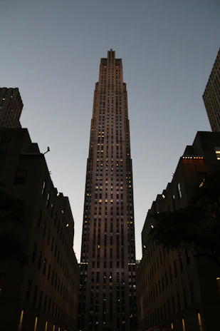 Luxurious residential towers illuminated at dusk, showcasing elegant architectural lines.