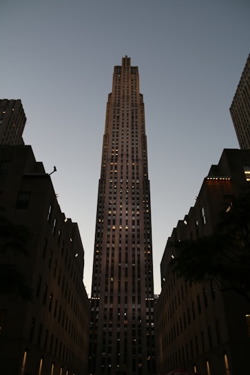 A sleek high-rise tower of Rise with 9 by Trilight glowing warmly at dusk.