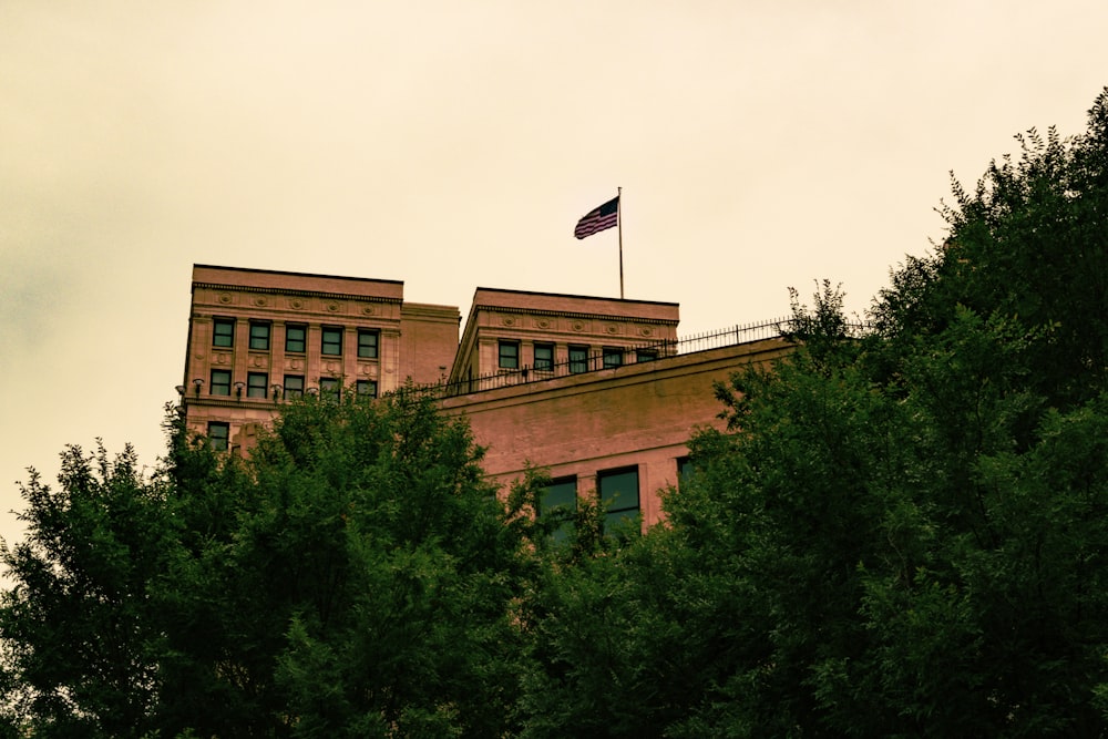 a tall building with a flag on top of it