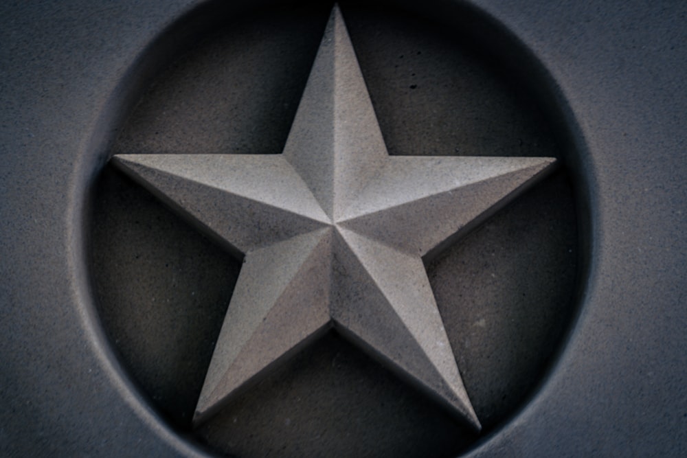 a silver star on a black surface