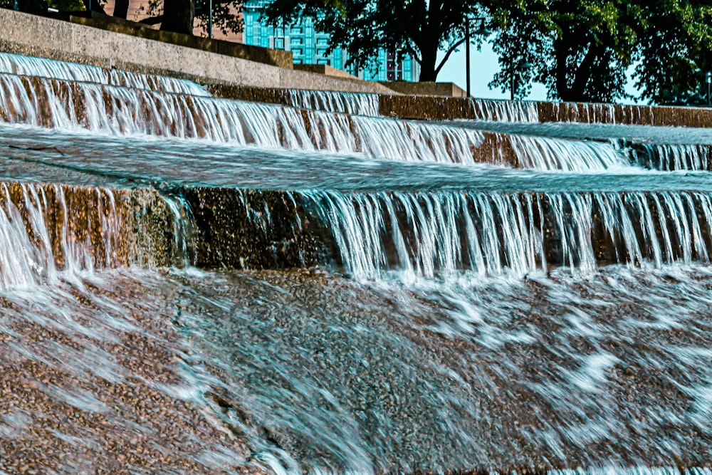 a man riding a skateboard on top of a waterfall