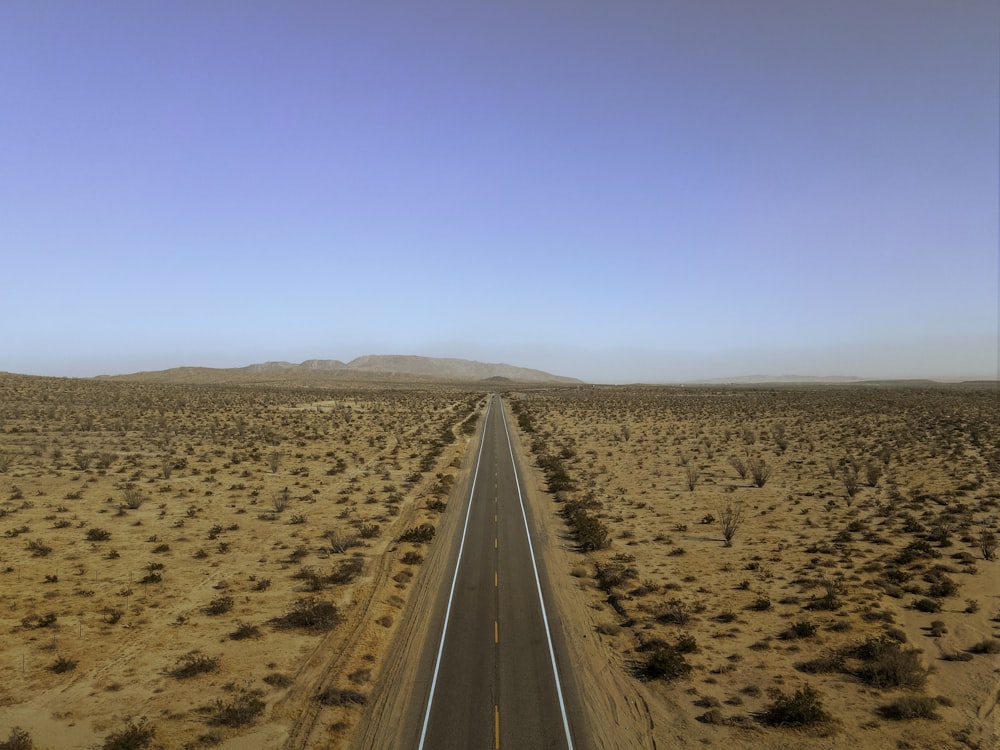 an aerial view of a road in the middle of the desert