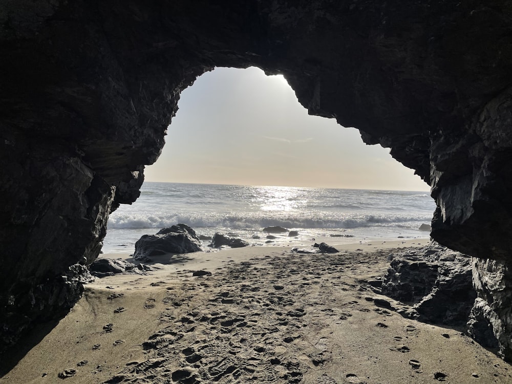 a view of the ocean through a cave