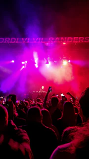 Atmospheric photo of the audience captivated during one of Lorenzo's live performances with violet accent lighting.