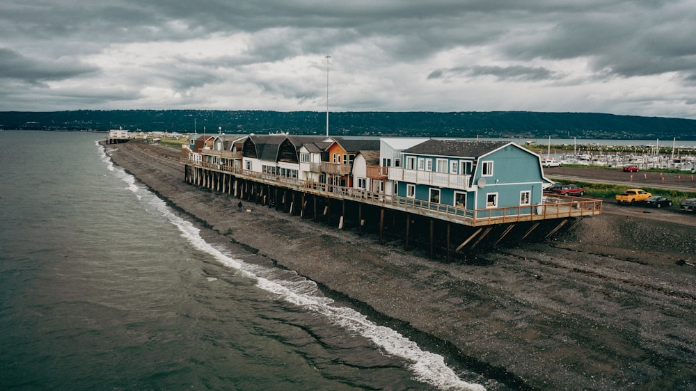 a pier with houses on top of it on a cloudy day