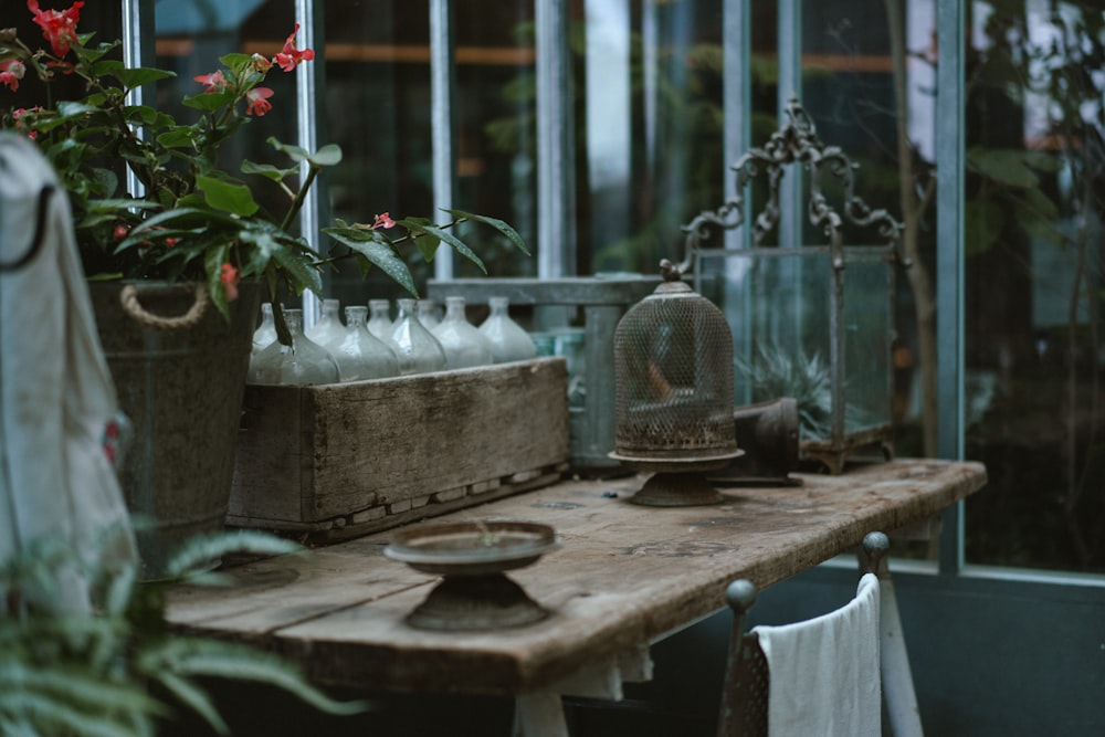 a wooden table topped with lots of plants