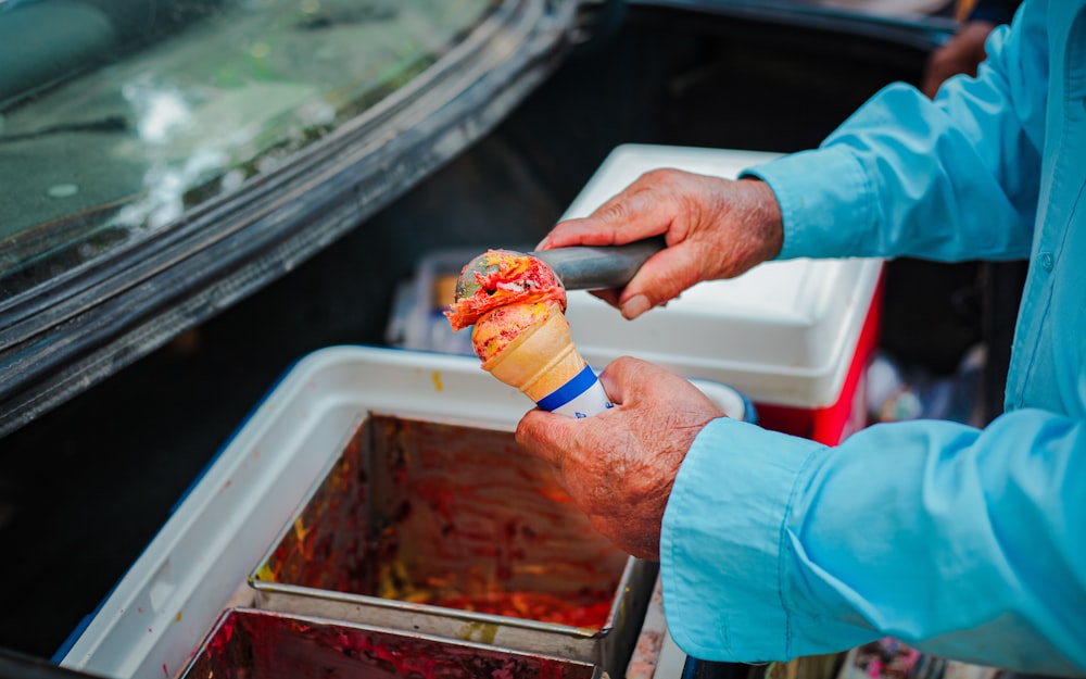 a man holding an ice cream cone in his hand