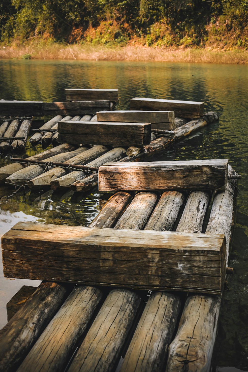 a wooden dock sitting in the middle of a lake