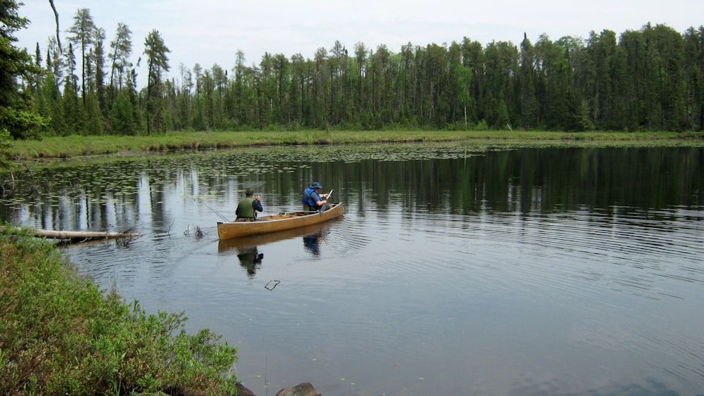 two people in a canoe on a lake