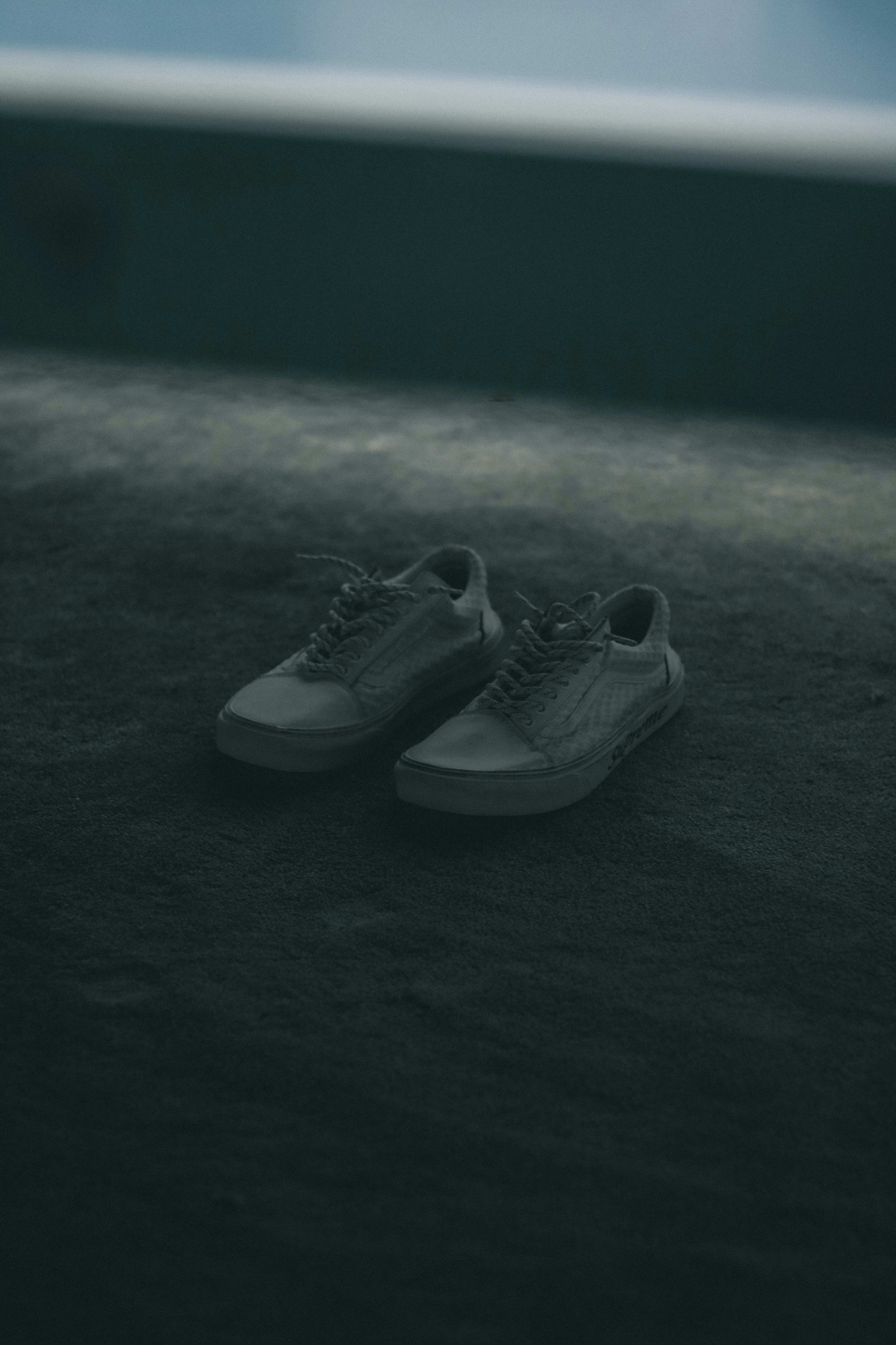 a pair of tennis shoes sitting on the ground