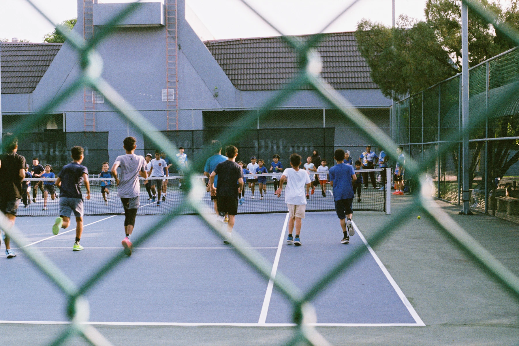 Coach and child on tennis court