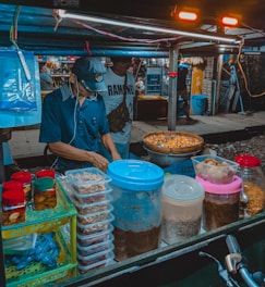 Close-up of a chef preparing fresh ingredients at a mobile food stall.