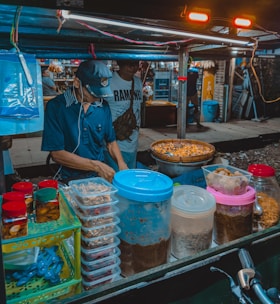 Close-up of a chef preparing fresh ingredients at a mobile food stall.