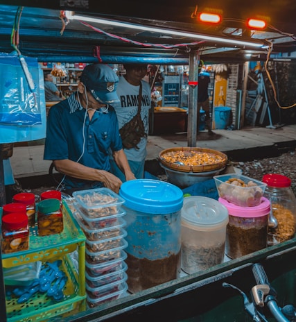 A close-up of a chef preparing a traditional street food dish.