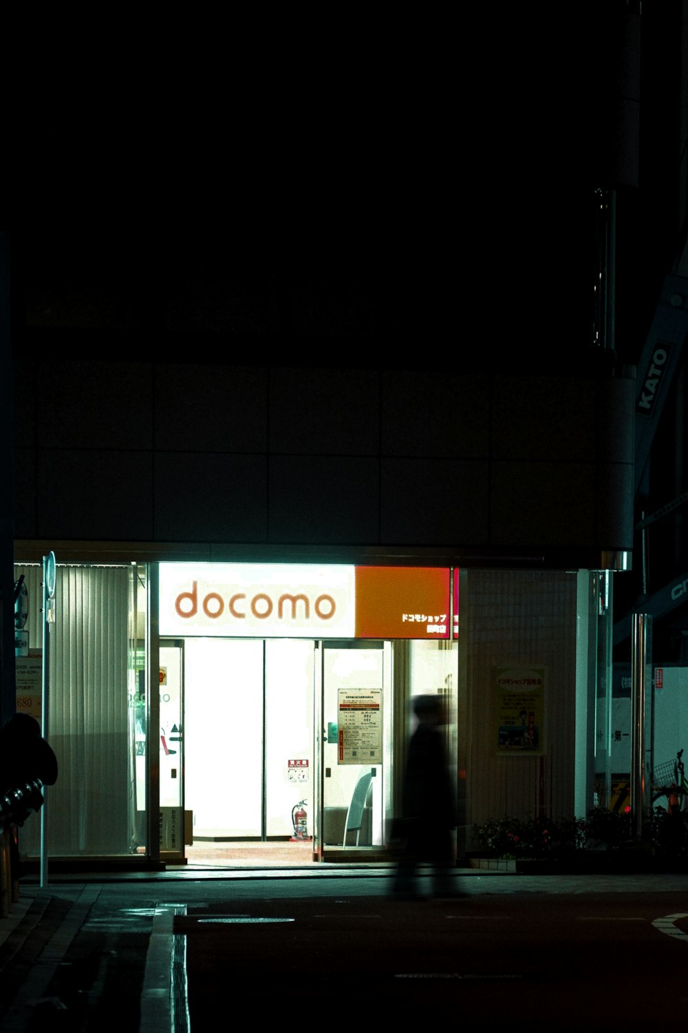 a person walking down a street at night