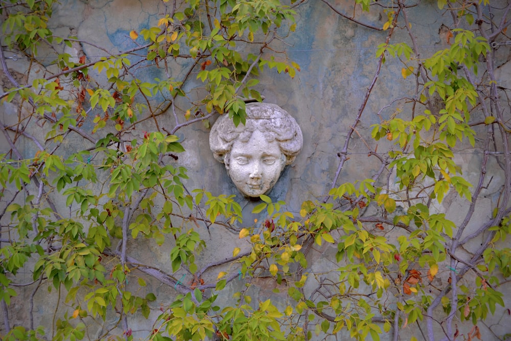 a statue of a woman's head on the side of a building