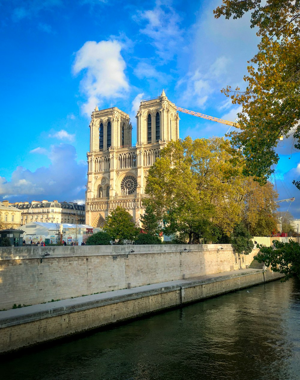 a large cathedral towering over a city next to a river