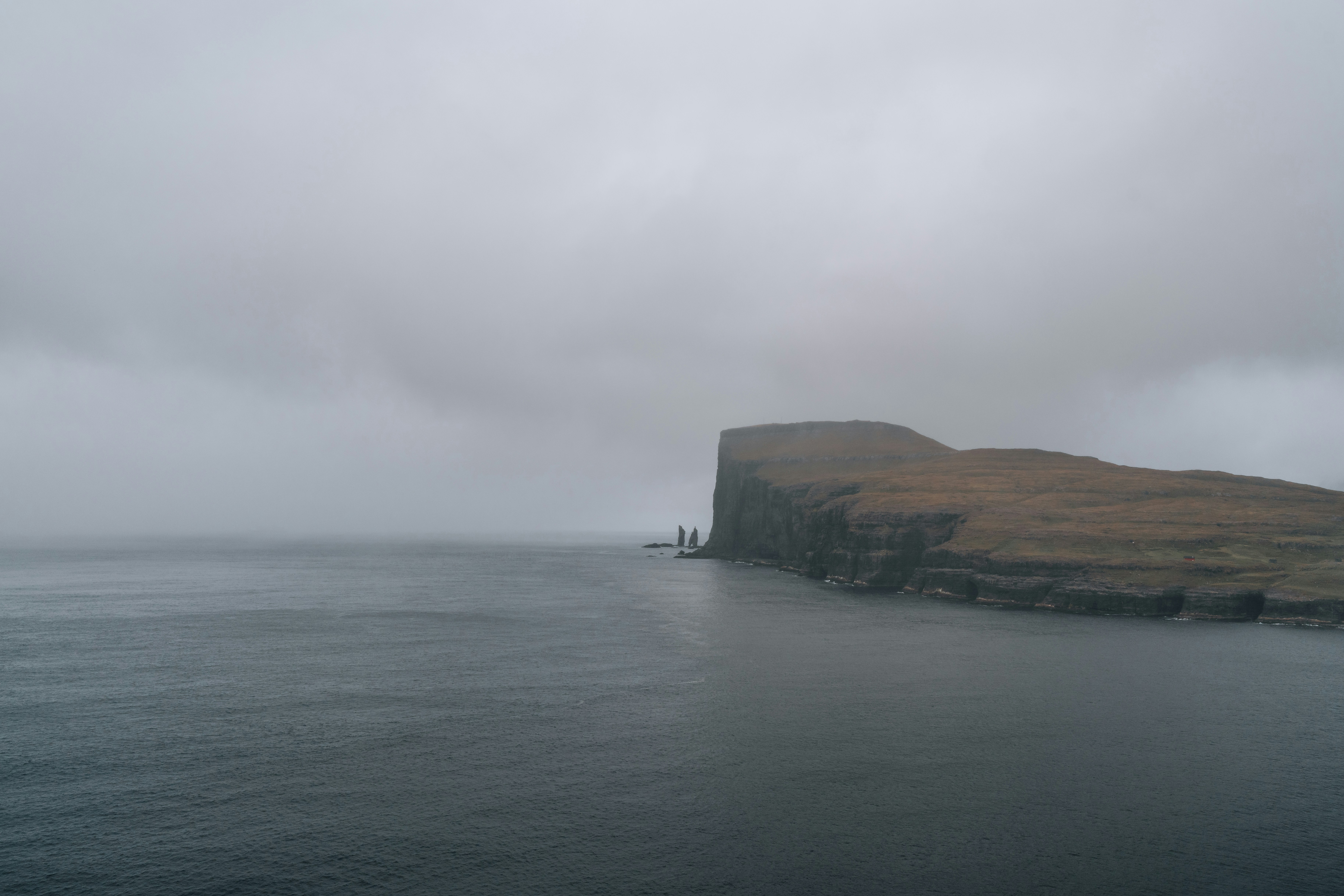 a large body of water with a small island in the middle of it, 