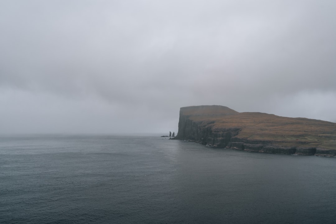 a large body of water with a small island in the middle of it,