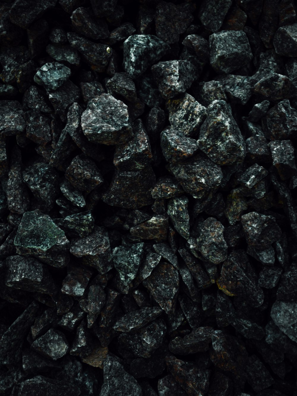 a pile of black rocks sitting next to each other