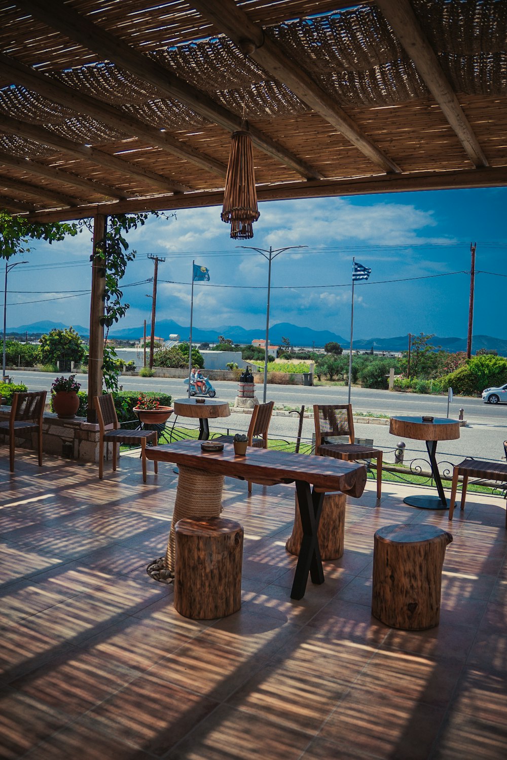 a wooden deck with benches and tables on it