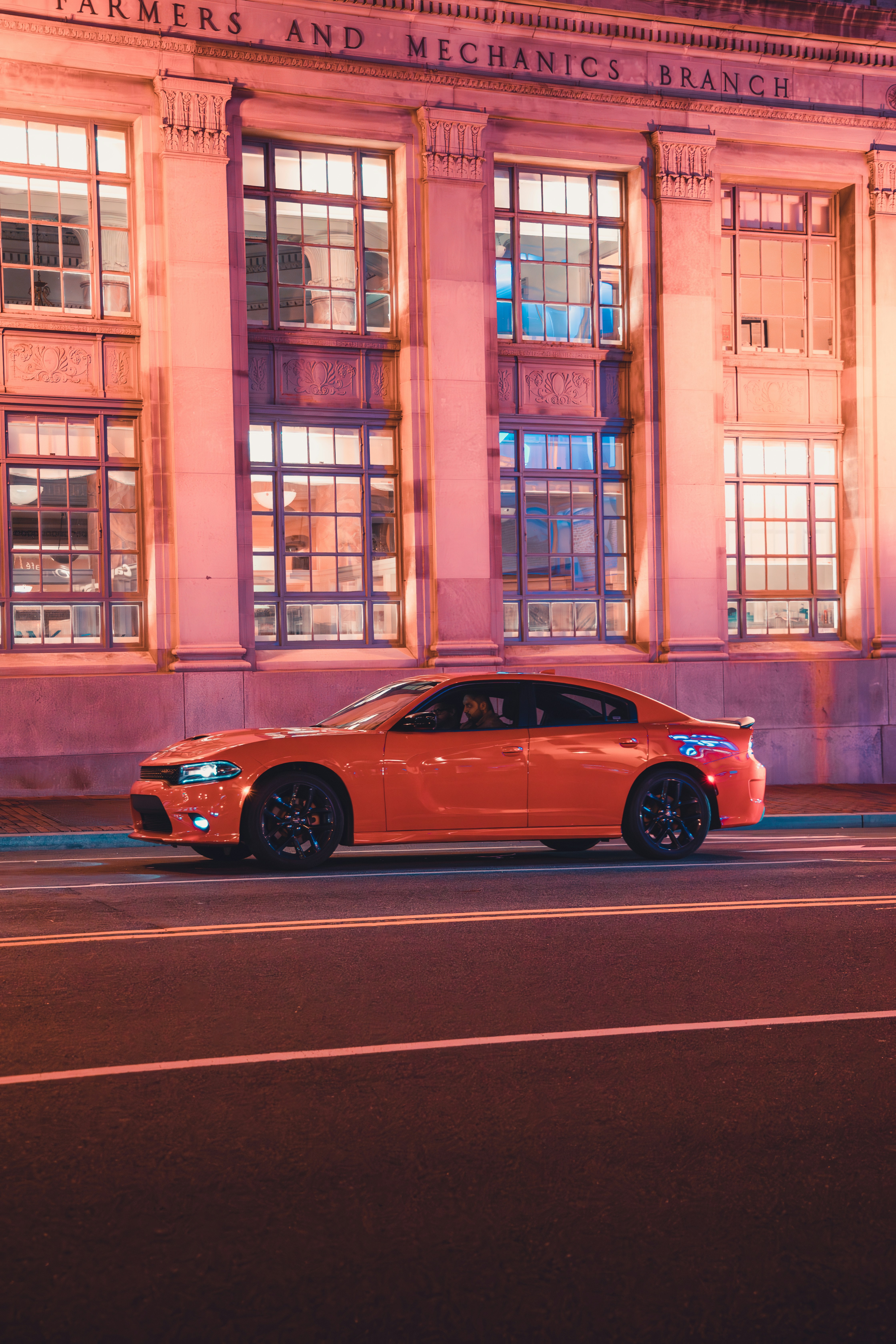 a red car parked in front of a building