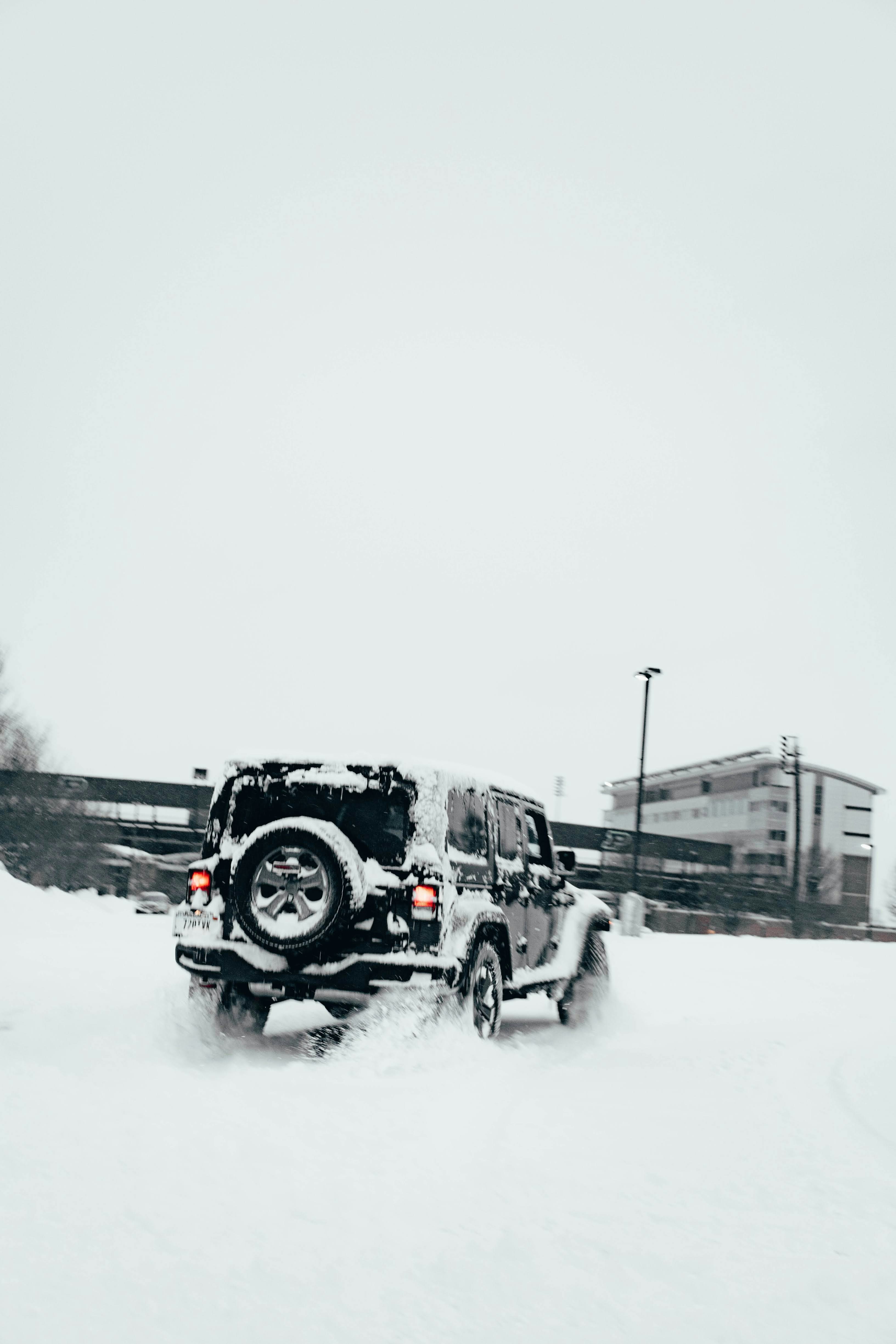 A jeep driving down a snow covered road photo – Free Purdue university ...
