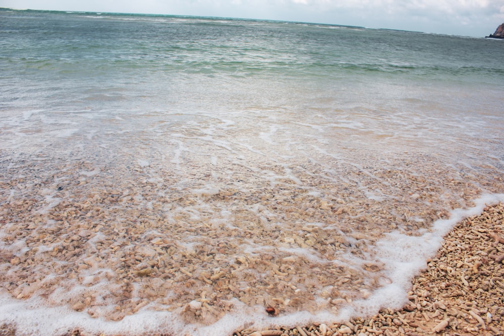 a beach with waves coming in and out of the water