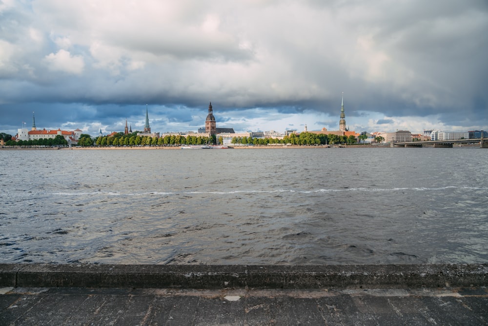 a large body of water with a city in the background