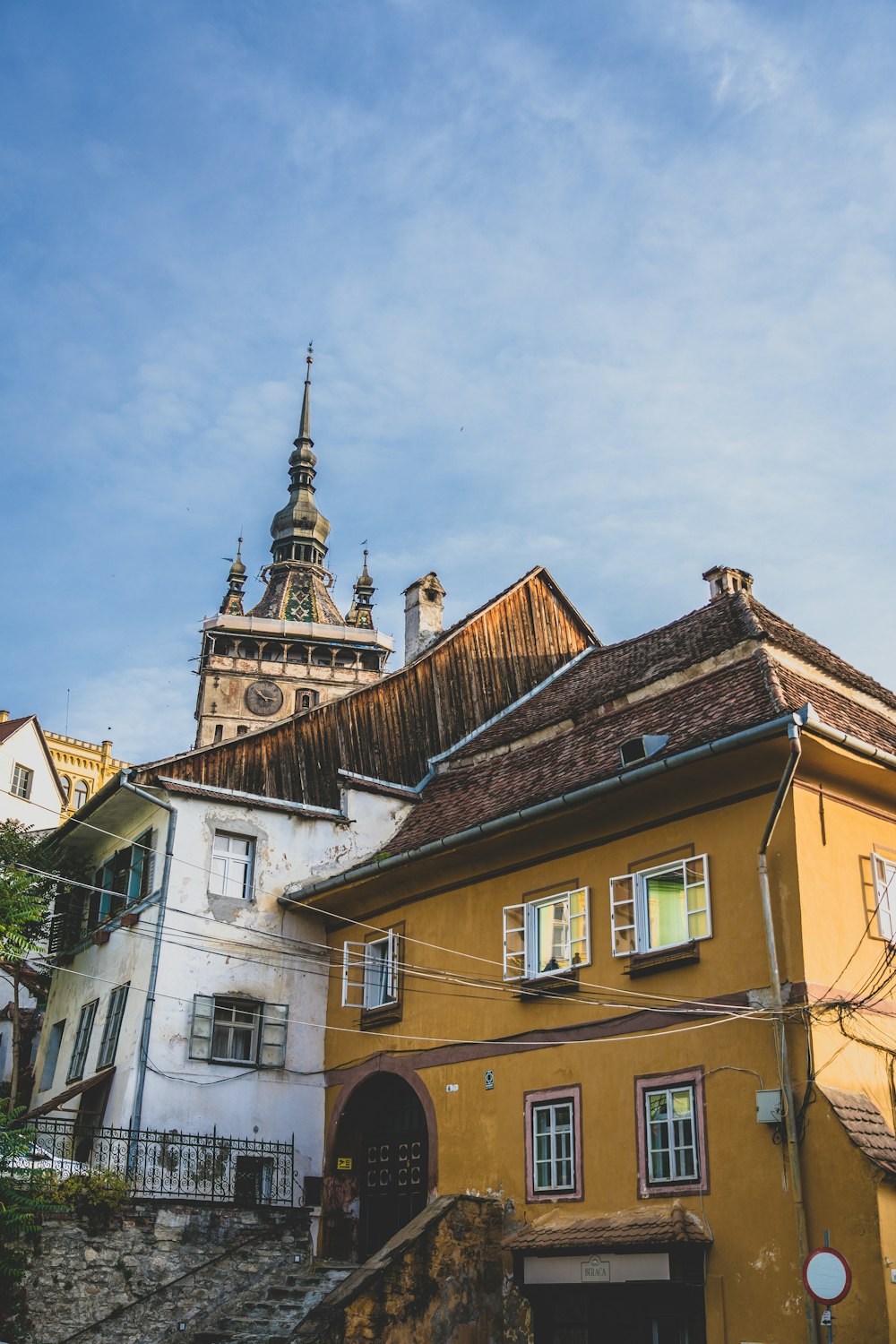 a yellow building with a steeple on top of it