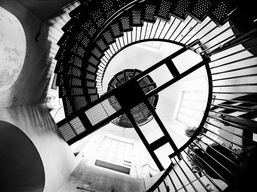 a black and white photo of a spiral staircase