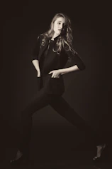 A model posing in a deep burgundy velvet suit, exuding confidence and sophistication.