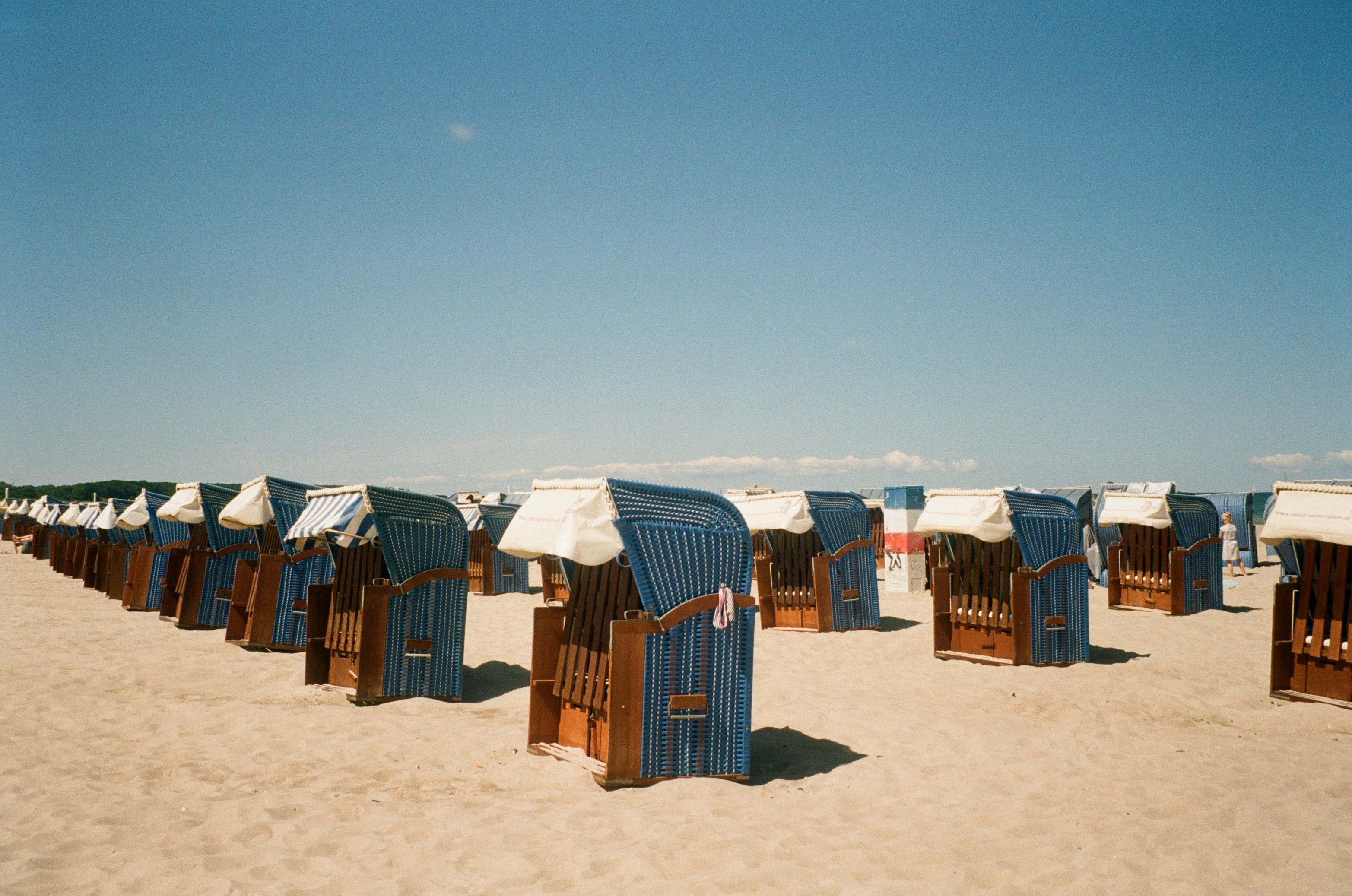 a row of beach chairs sitting on top of a sandy beach