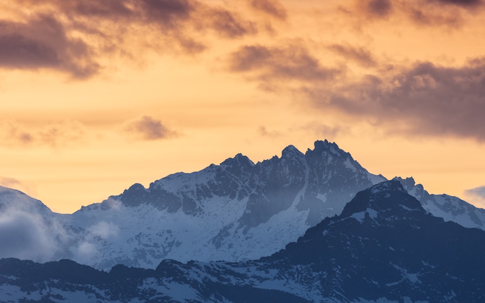 a view of the top of a mountain at sunset