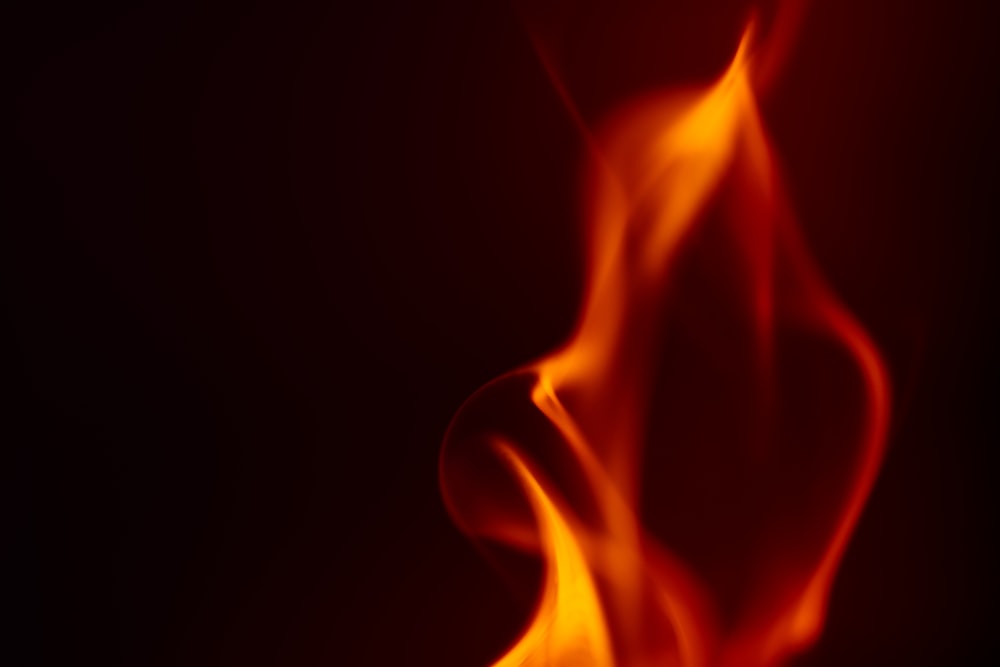 a close up of a red fire on a black background