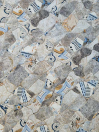 Close-up of a vibrant mosaic tile pattern inspired by Mani's rugged landscape.