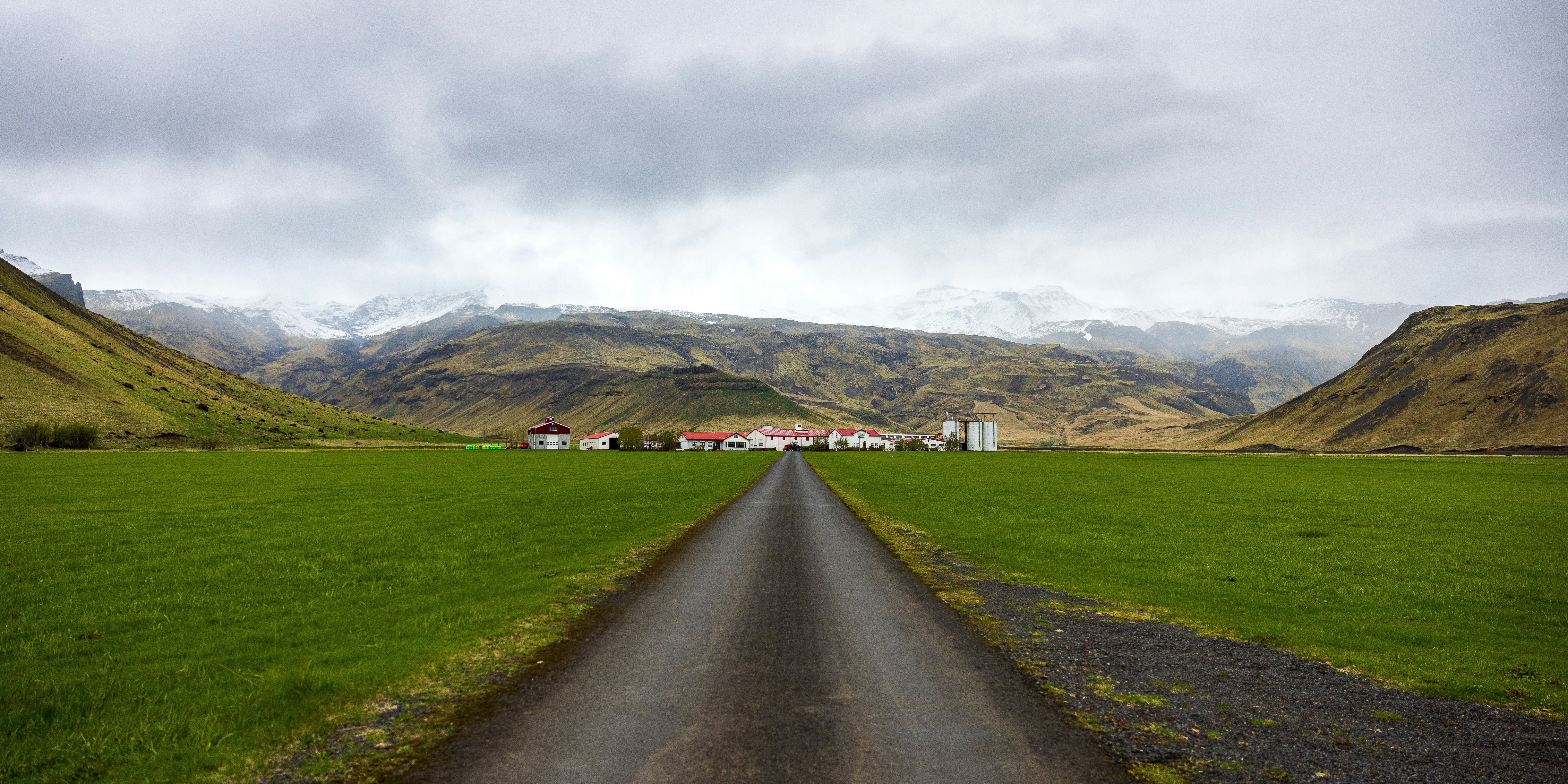 a road going through a lush green valley