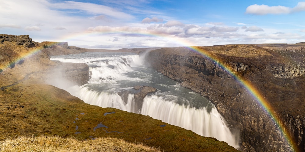 a waterfall with a rainbow in the middle of it