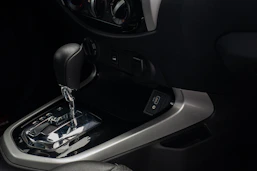 a close up of a car's gear box and steering wheel