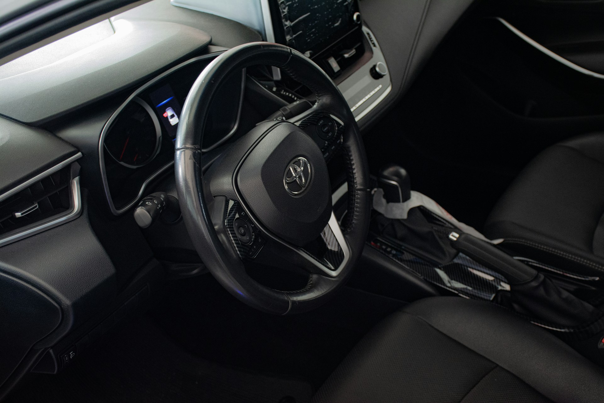 the interior of a car with a steering wheel and dashboard