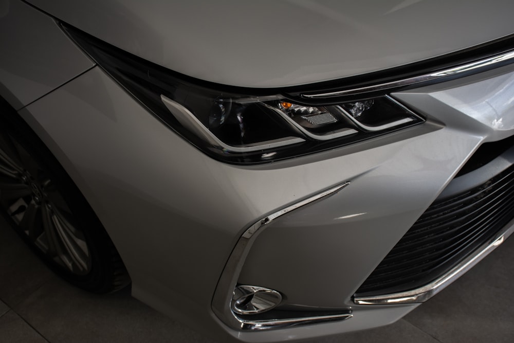 a close up of the front of a silver car