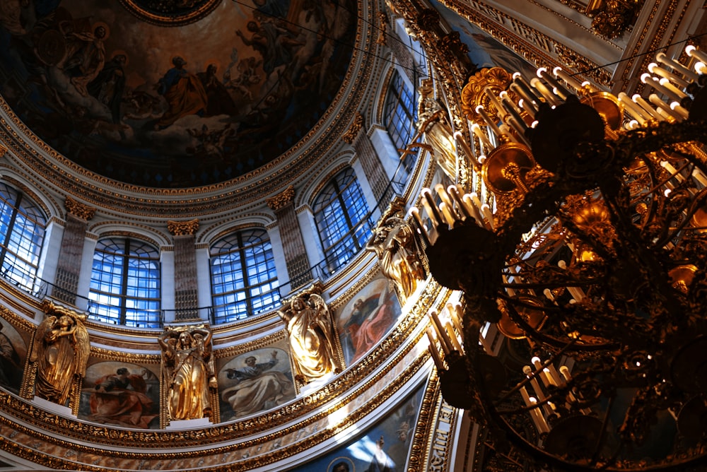 the ceiling of a large building with paintings on it