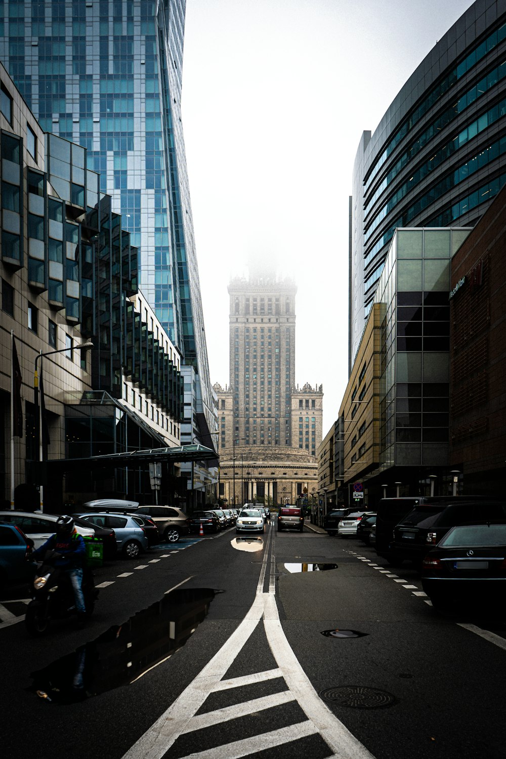 a city street with a tall building in the background