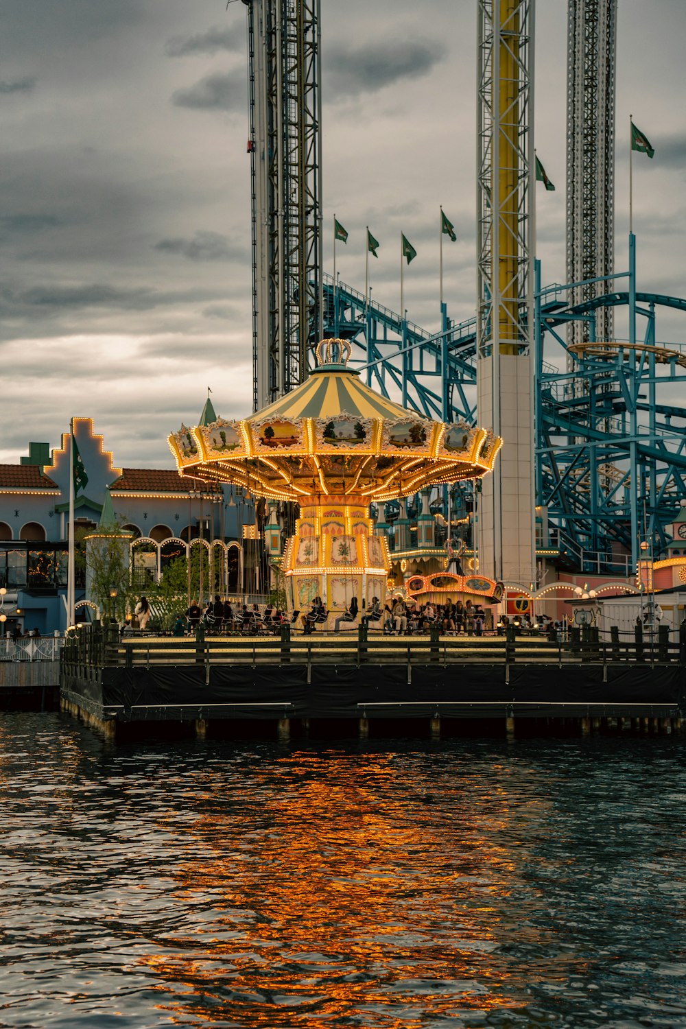 an amusement park with a carousel on the water