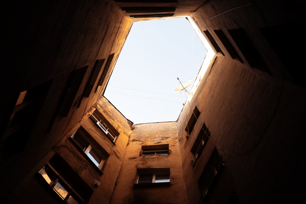 looking up at the sky through a window in a building